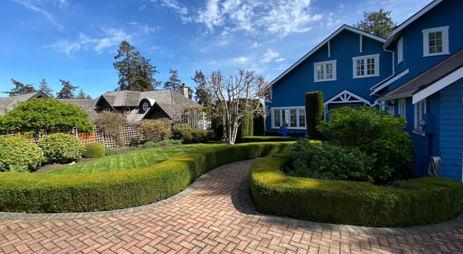 Rounded topiary hedge and manicured front garden